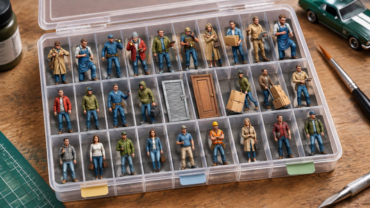 Painted 1:64 scale figures neatly separated in an organized compartment box on a hobby workbench