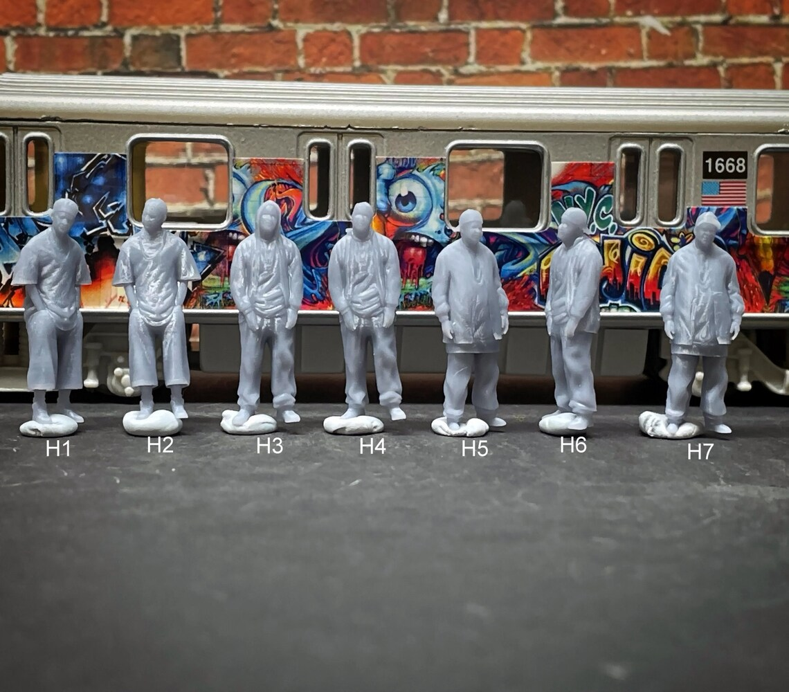 a group of toy figures standing in front of a train