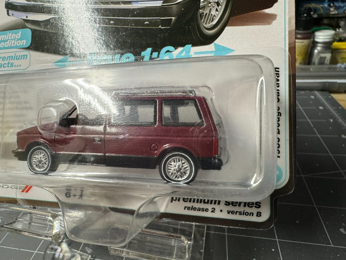 1:64 AutoWorld 1985 Dodge Caravan -Crimson Red w/Black Lower Sides #AWSP167B